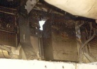Closeup of rocket damage to hull from inside